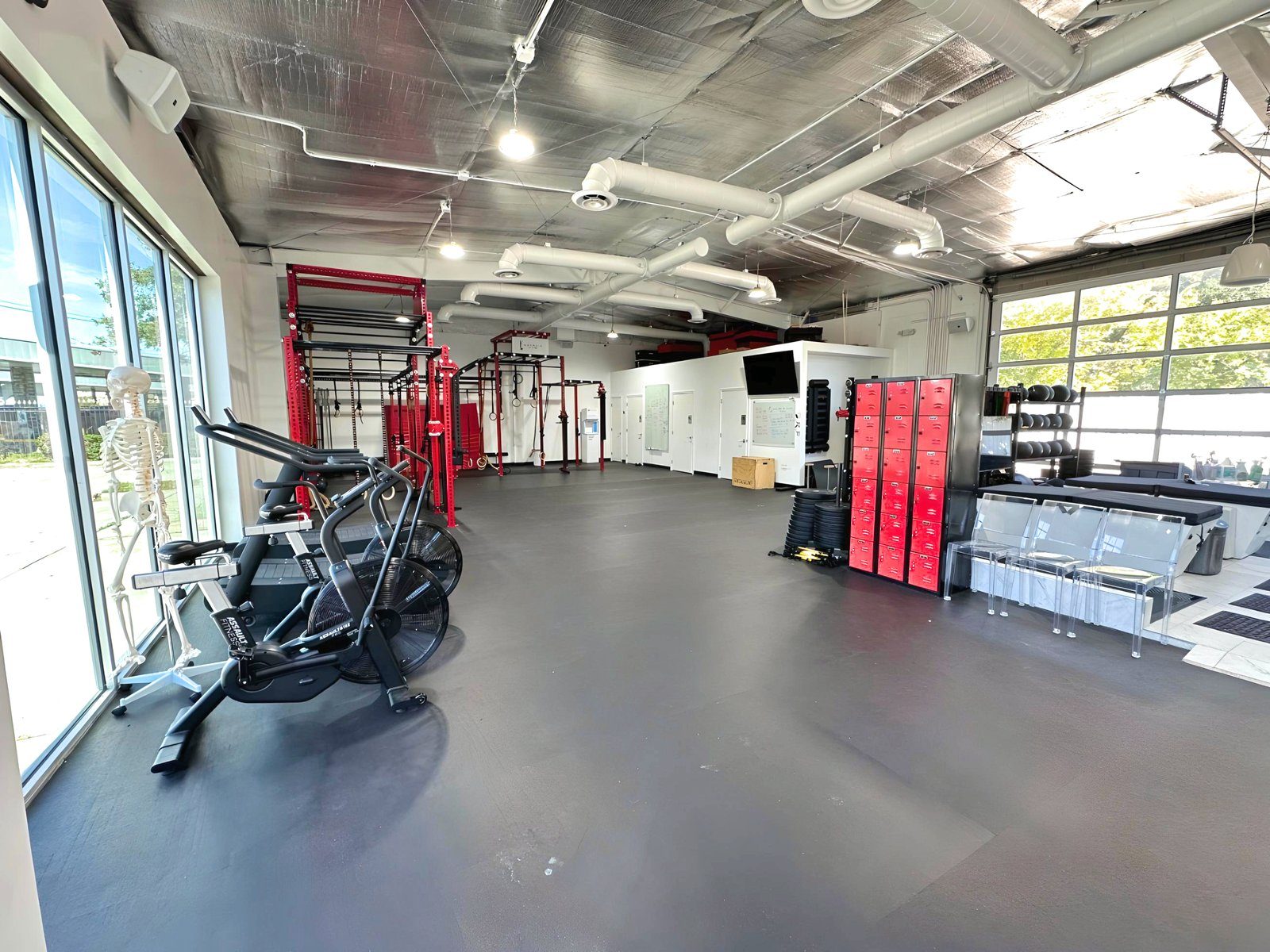 The training floor of the converted auto-repair building, glass walls on both ends.